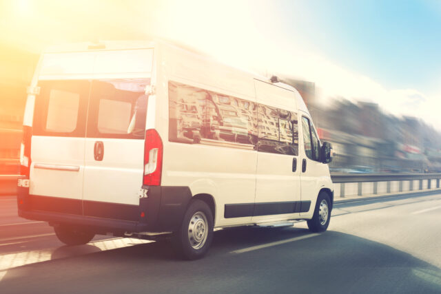 unrecognizable,small,passenger,van,hurry,up,on,highway,at,city