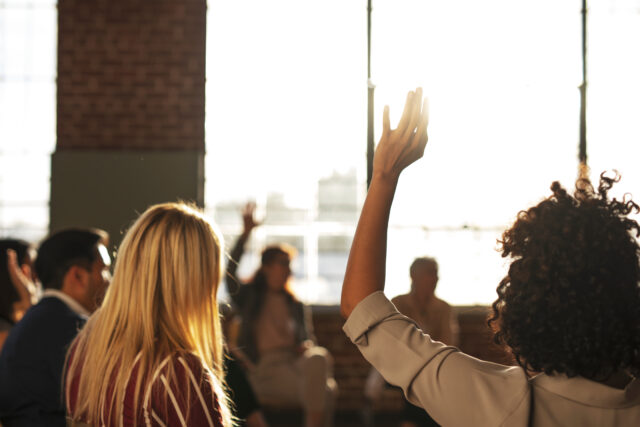 people,raised,their,hand,in,a,meeting