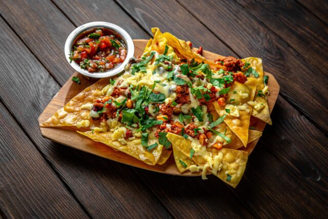 nachos,chips,and,dipon,dark,boards,background.,menu,for,a