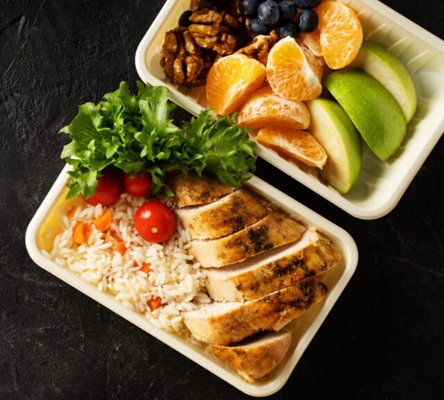 lunch,box,with,chicken,,rice,,vegetables,,tomatoes,,salad,,fruits,and