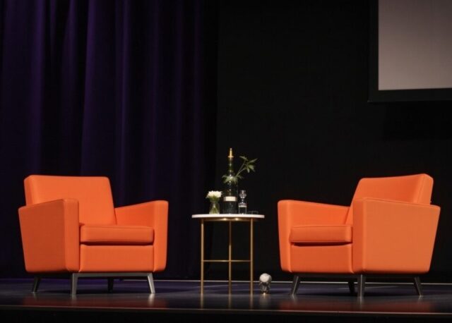 fireside,chat,on,stage,with,2,cosmic,orange,chairs,and